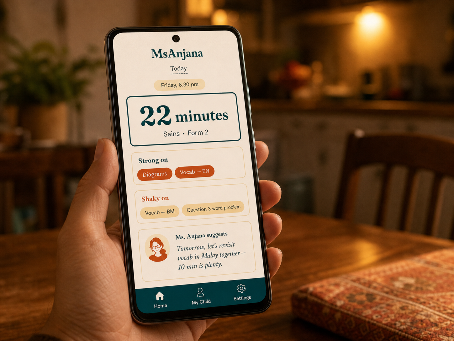 phone in a parent's hand showing the MsAnjana companion app — today's session summary, strengths and weaknesses, suggestion from Ms. Anjana